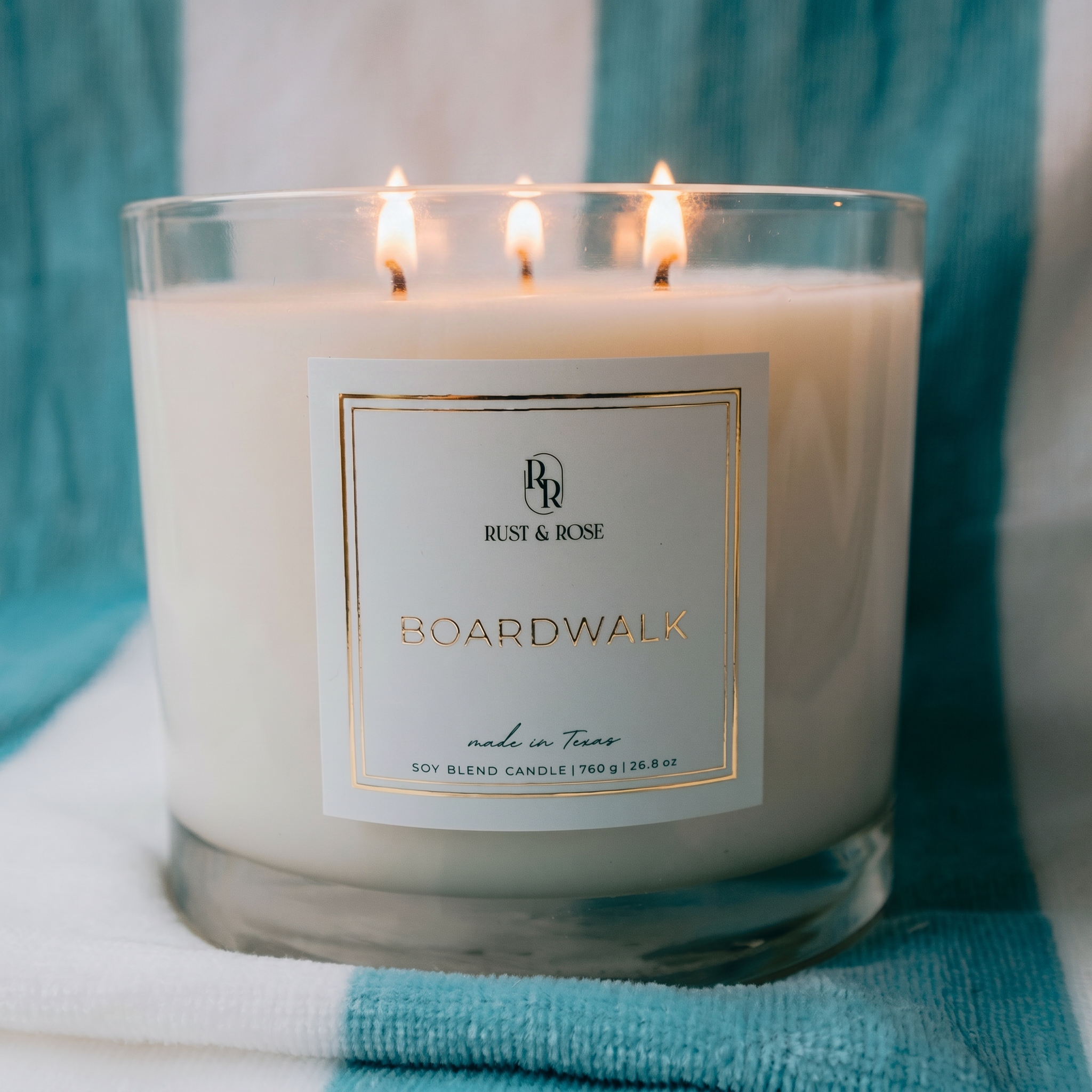 Candle with a label on a blue and white striped background